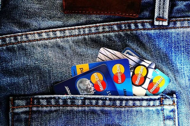 multiple canadian credit cards in a jeans back pocket