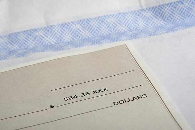 an american cheque sitting on a bank counter