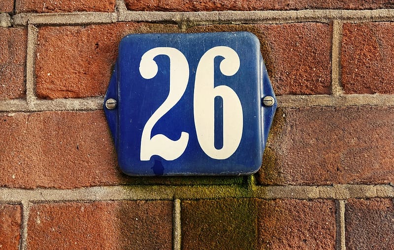 a civic number on a brick wall