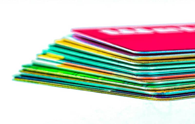 a stack of credit cards in multiple colors