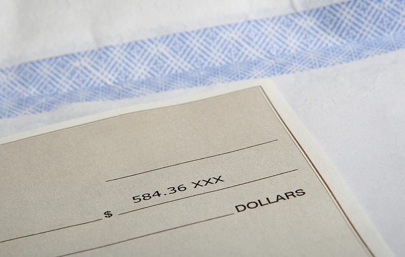 an american cheque sitting on a bank counter