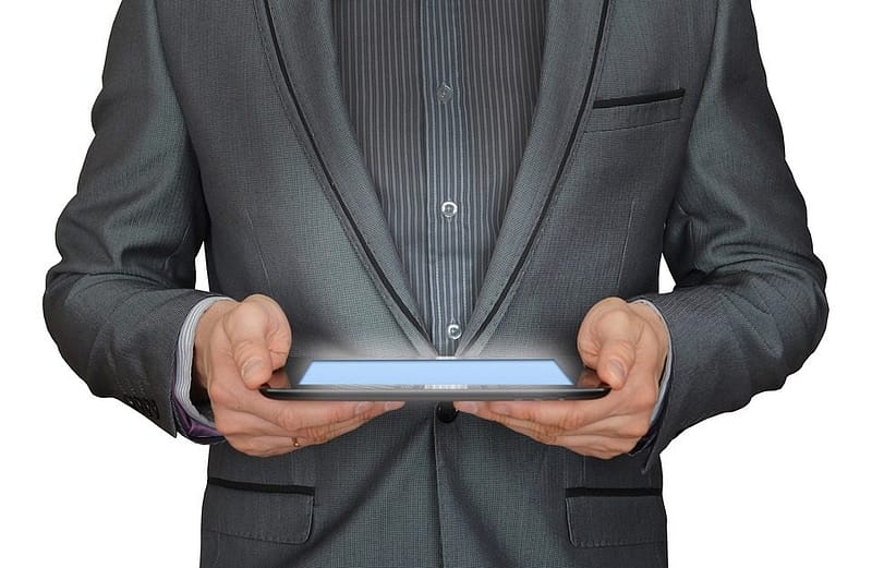 man holding a ipad looking at his personal finances