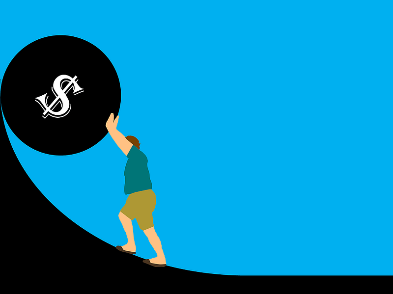 man pushing a large mortgage up a hill
